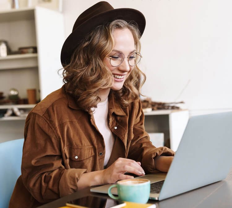 image of cheerful woman working with laptop while